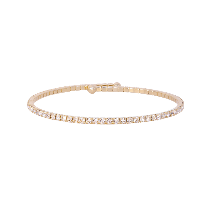 Gold bracelet with clear stones on a white background