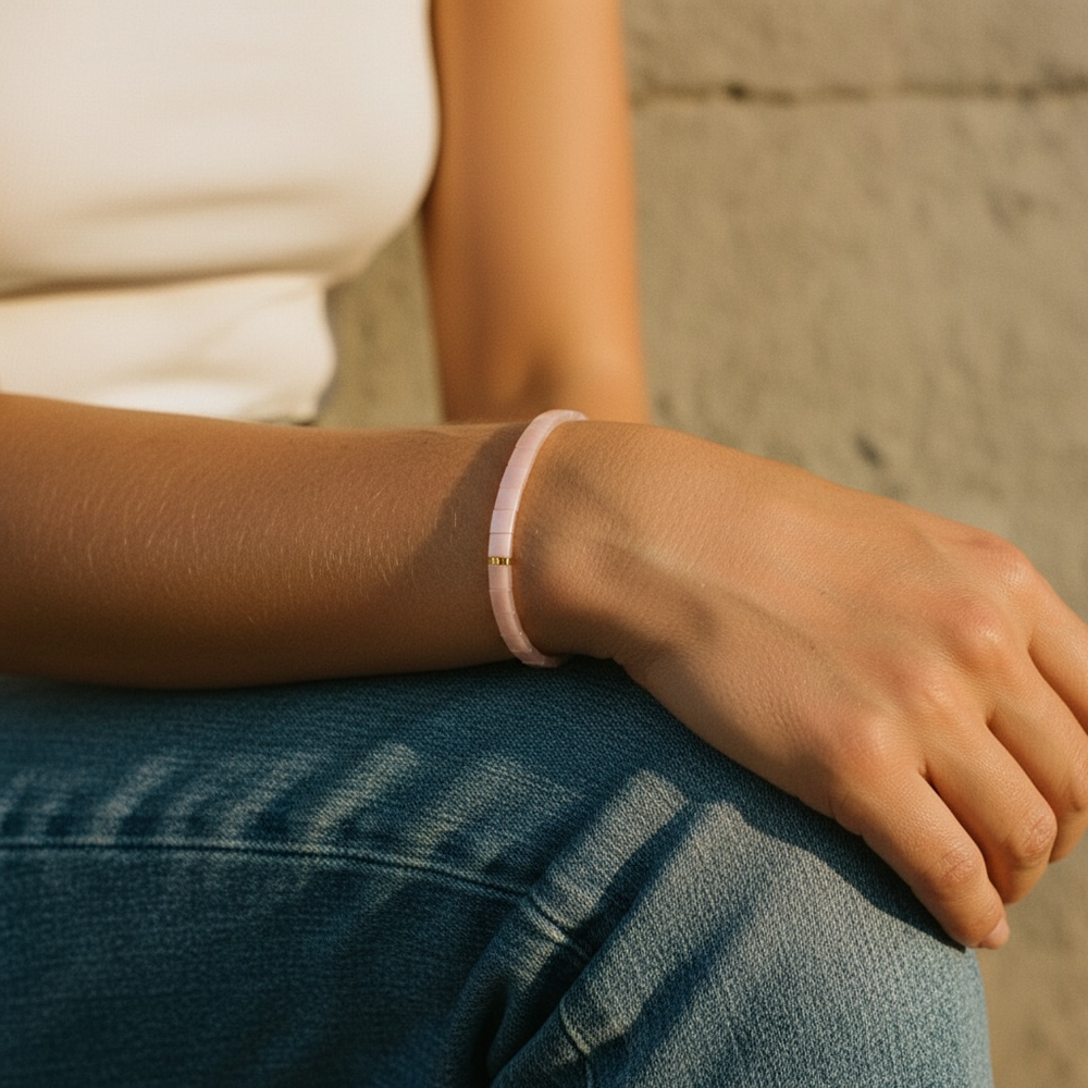 Blush Tila Bracelet worn on wrist with white top and denim showing minimalist pink design