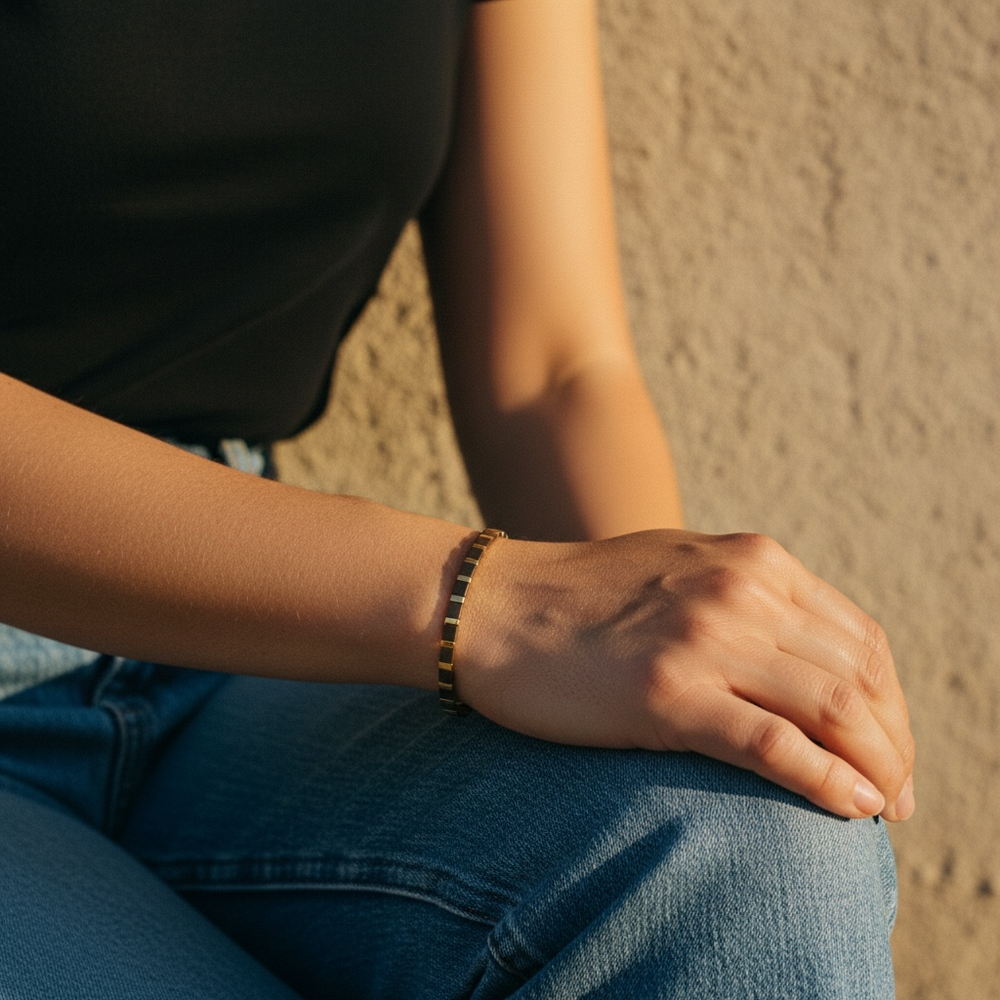 Bronze Age Tila Bracelet worn on wrist with black tee and denim in golden hour light