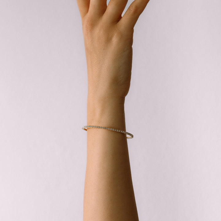 Classic crystal bangle bracelet gold worn on wrist – Sugar Bean Jewelry