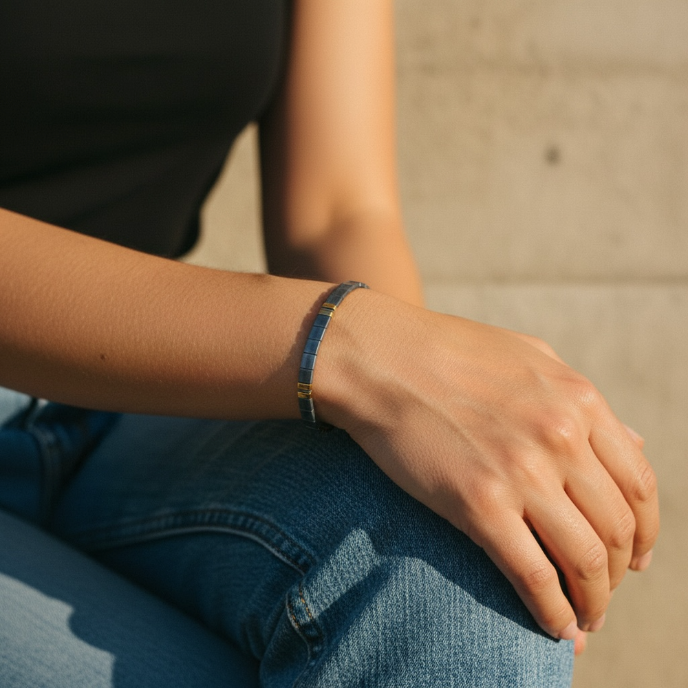 Denim Luxe Tila Bracelet worn on wrist with black top and denim showing sophisticated slate blue and gold