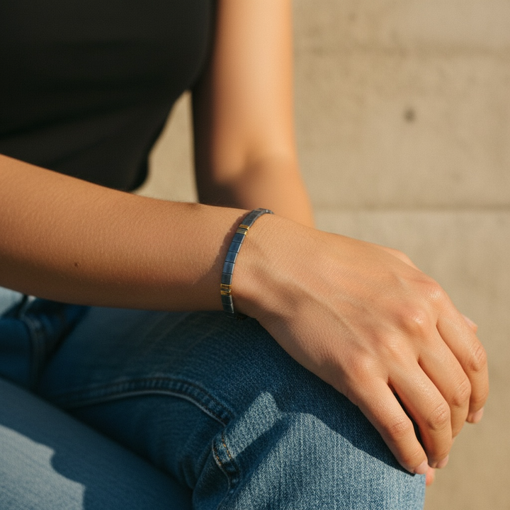 Denim Luxe Tila Bracelet worn on wrist with black top and denim showing sophisticated slate blue and gold