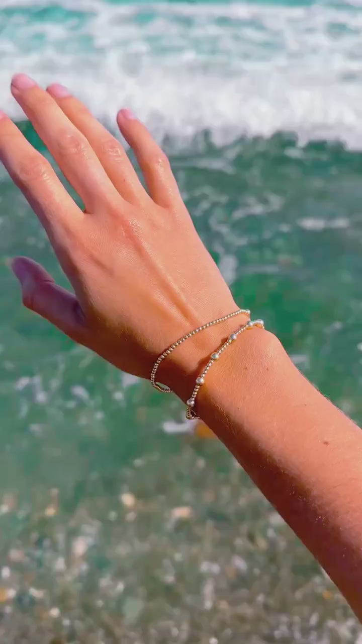 Steadfast Pulse gold-filled bracelet stack in ocean surf
