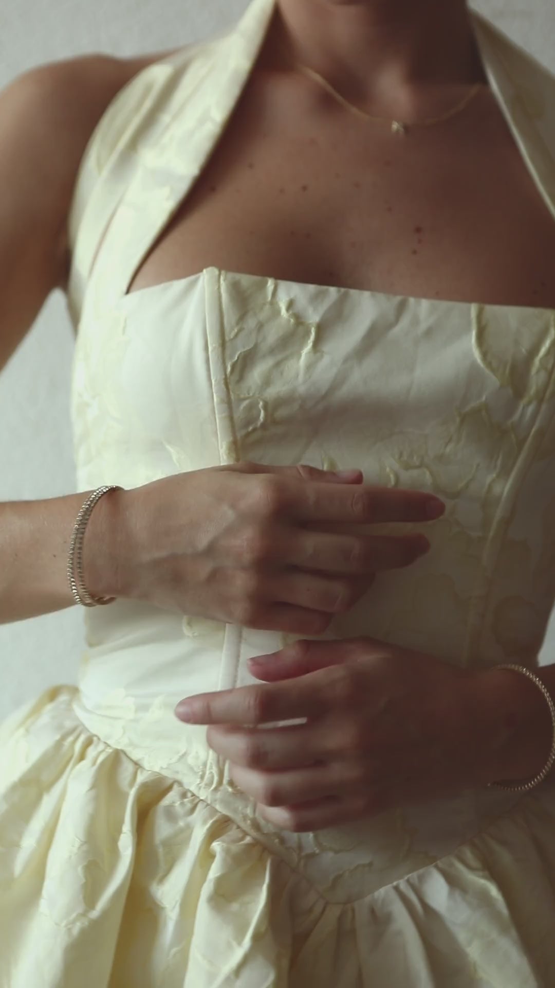 Gold crystal bangles worn with yellow dress