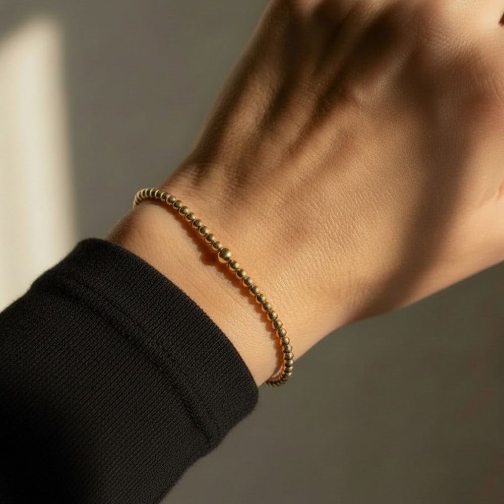 Steadfast 2mm gold filled bracelet worn on wrist – Sugar Bean Jewelry