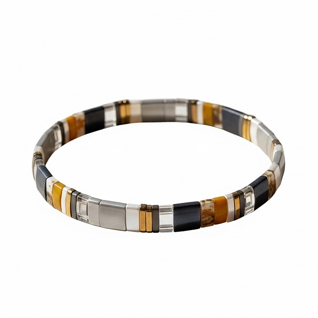 Storm Cloud Tila Bracelet showing gunmetal gray, black, mustard, and crystal Miyuki Tila beads on a white background