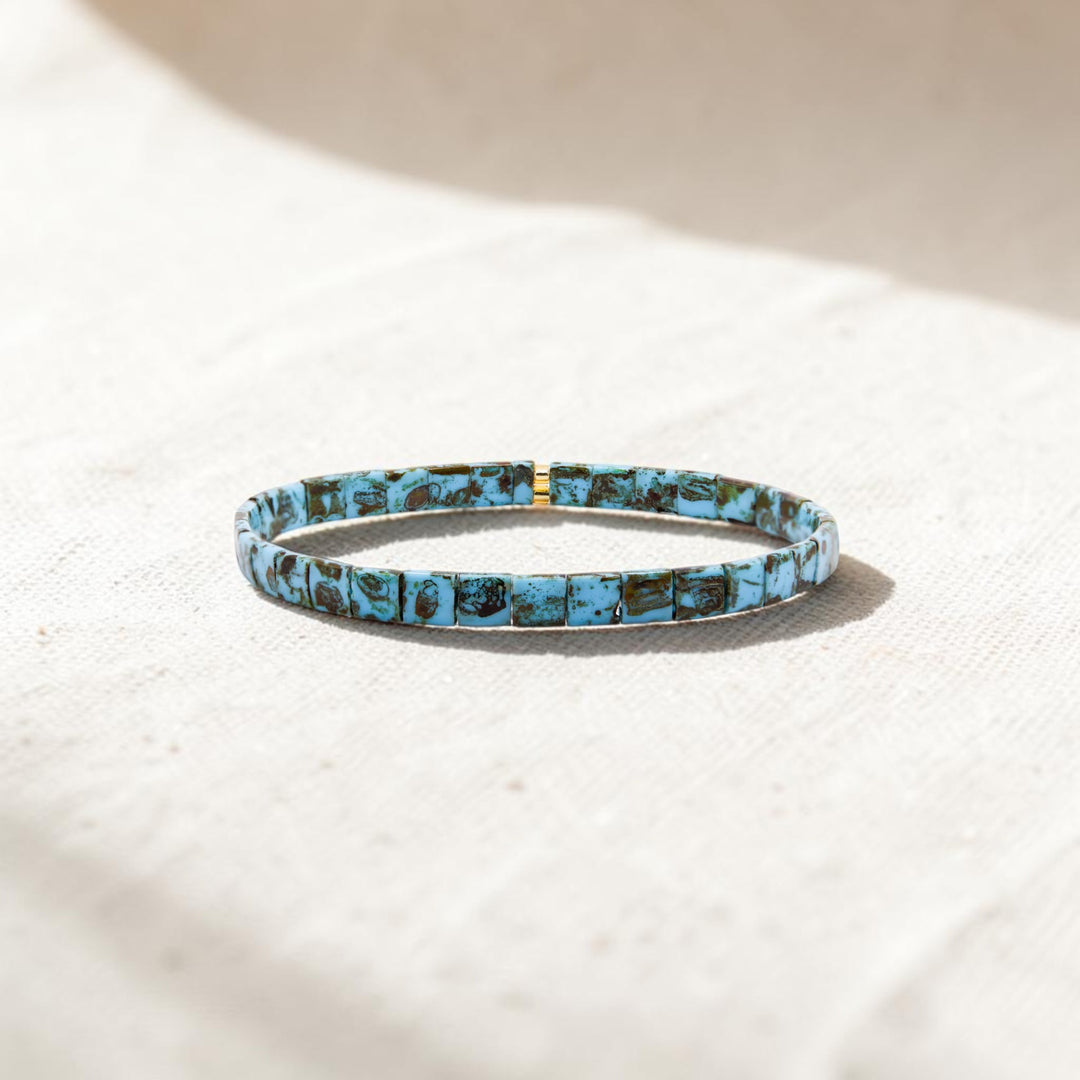 Turquoise Trail Gold Tila Bracelet styled on neutral background – hand-strung stretch bracelet – Sugar Bean Jewelry