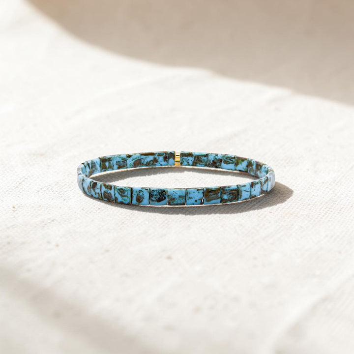 Turquoise Trail Gold Tila Bracelet styled on neutral background – hand-strung stretch bracelet – Sugar Bean Jewelry